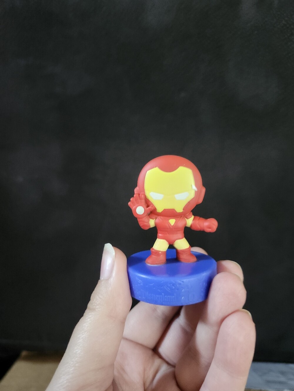 Red and Yellow Superhero Figure Toy on Blue Base